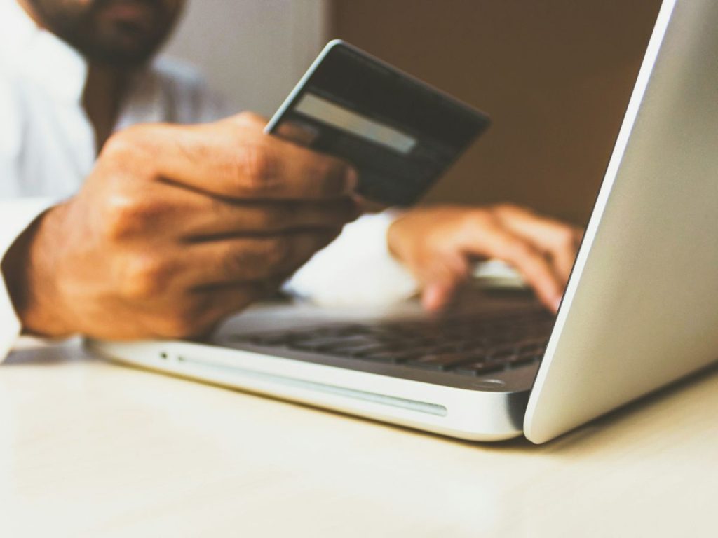 man doing payment on laptop